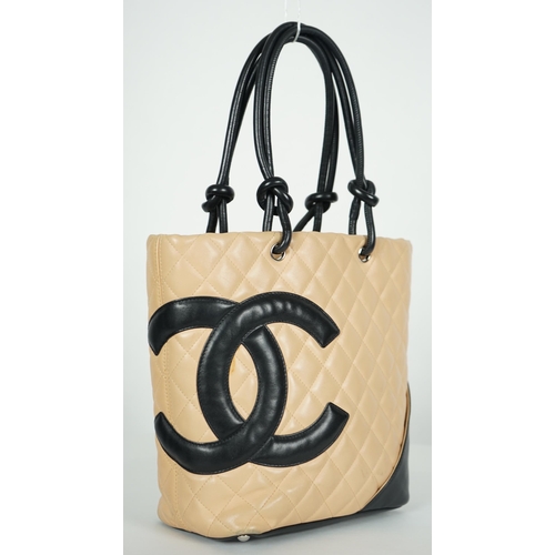 1134 - ** ** A Chanel Cambon Ligne black and beige quilted leather tote, the Cambon Ligne tote features a q... 