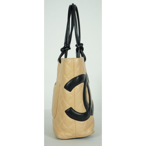 1134 - ** ** A Chanel Cambon Ligne black and beige quilted leather tote, the Cambon Ligne tote features a q... 