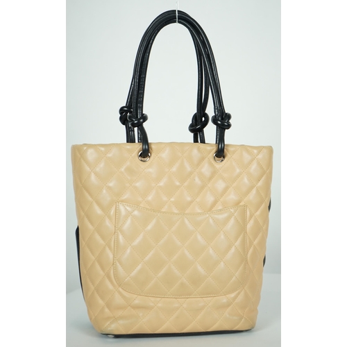 1134 - ** ** A Chanel Cambon Ligne black and beige quilted leather tote, the Cambon Ligne tote features a q... 