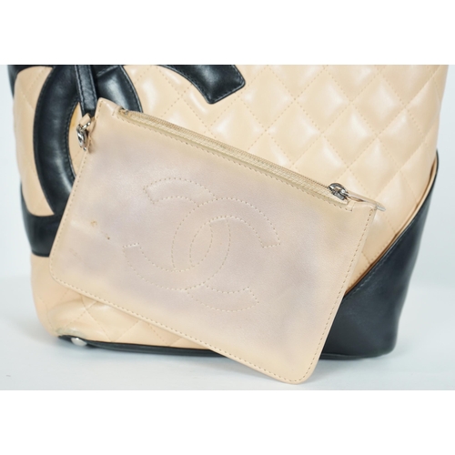 1134 - ** ** A Chanel Cambon Ligne black and beige quilted leather tote, the Cambon Ligne tote features a q... 