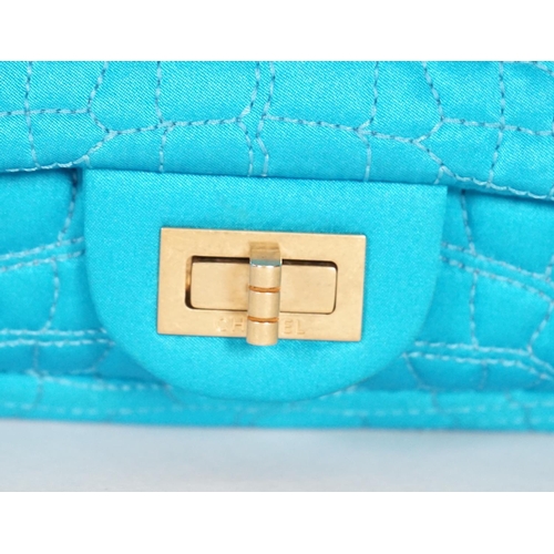 1136 - A Chanel medium-sized 2-55 bag in turquoise blue silk satin stitched with a quilted crocodile patter... 