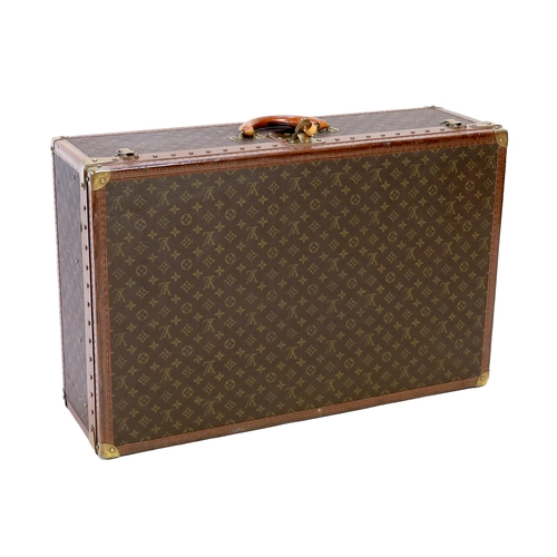 1145 - A Louis Vuitton monogram canvas and tan leather suitcase, with label for Paris and Nice number 19849... 