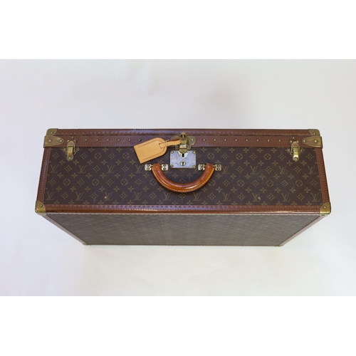 1145 - A Louis Vuitton monogram canvas and tan leather suitcase, with label for Paris and Nice number 19849... 