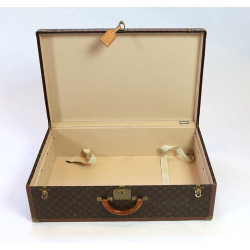 1145 - A Louis Vuitton monogram canvas and tan leather suitcase, with label for Paris and Nice number 19849... 