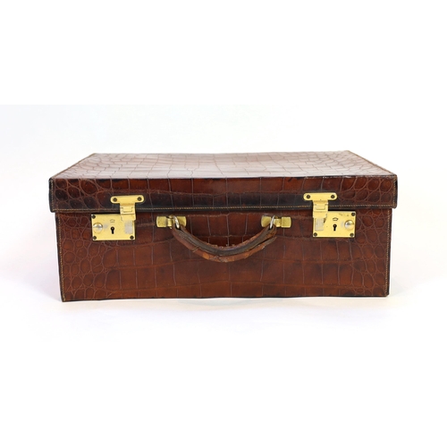 1146 - A 1920's crocodile skin suitcase, with gilt initials EH and locks stamped English Lever, width 50cm,... 