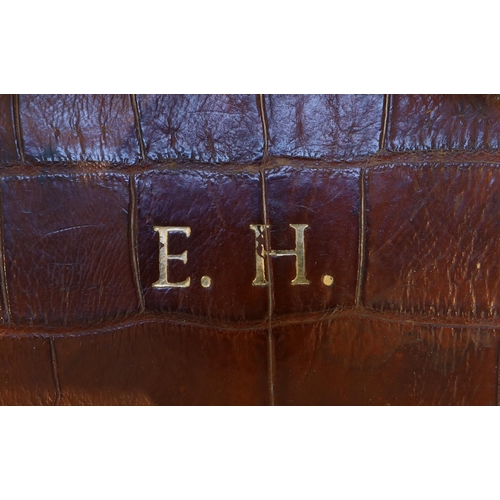 1146 - A 1920's crocodile skin suitcase, with gilt initials EH and locks stamped English Lever, width 50cm,... 