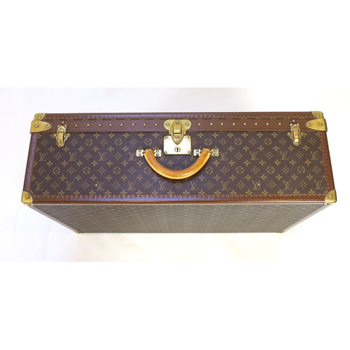 1147 - A Louis Vuitton monogrammed canvas and tan leather suitcase, with internal tray and Paris label numb... 