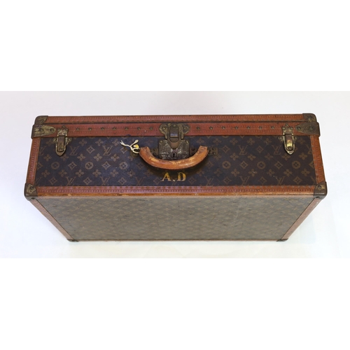 1148 - A vintage Louis Vuitton suitcase with monogram canvas and tan leather, initialled A.D, interior with... 