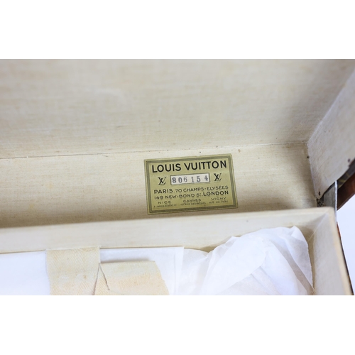 1148 - A vintage Louis Vuitton suitcase with monogram canvas and tan leather, initialled A.D, interior with... 