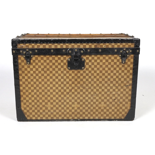 1149 - A Louis Vuitton Damier trunk, with black painted metal mounts and brass studded wooden slats over th... 