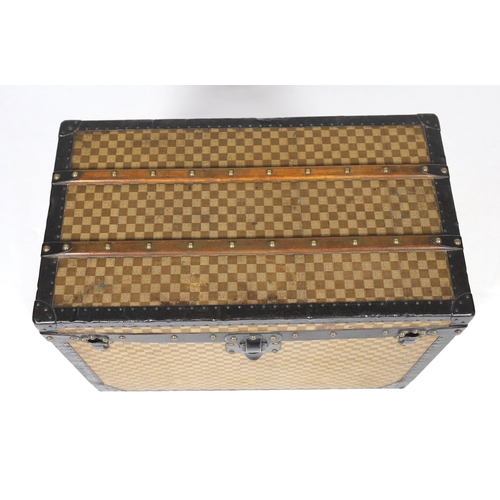 1149 - A Louis Vuitton Damier trunk, with black painted metal mounts and brass studded wooden slats over th... 