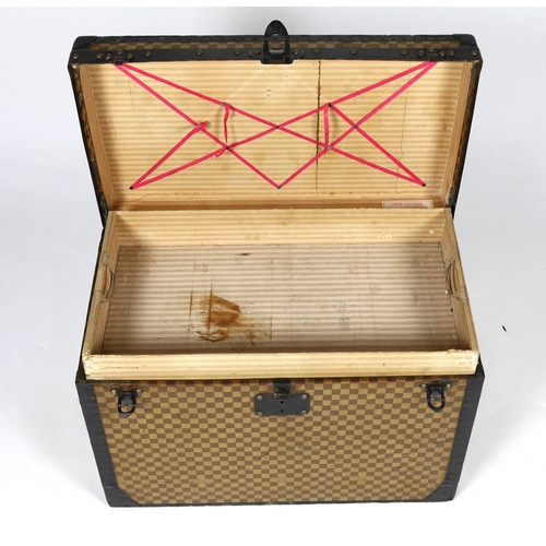 1149 - A Louis Vuitton Damier trunk, with black painted metal mounts and brass studded wooden slats over th... 