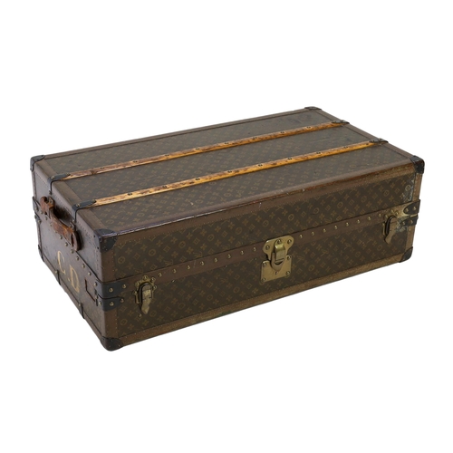 1150 - A vintage Louis Vuitton monogram canvas wardrobe trunk, with iron and brass mounts, and brass studde... 