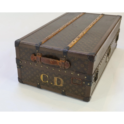 1150 - A vintage Louis Vuitton monogram canvas wardrobe trunk, with iron and brass mounts, and brass studde... 