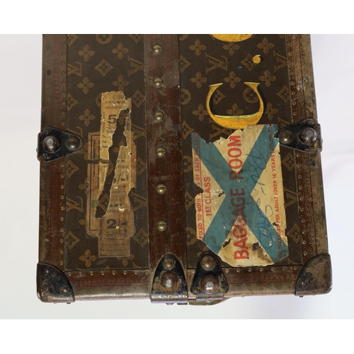 1150 - A vintage Louis Vuitton monogram canvas wardrobe trunk, with iron and brass mounts, and brass studde... 