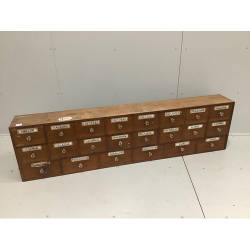 1173 - A nest of pine pharmacist's drawers, width 183cm, height 49cm