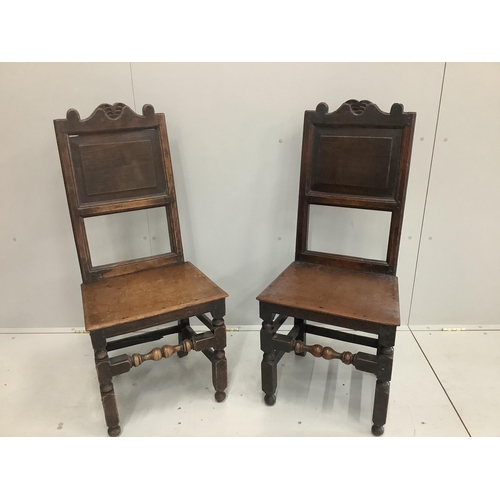 1200 - A pair of 17th century oak panel back chairs, width 47cm, height 108cm