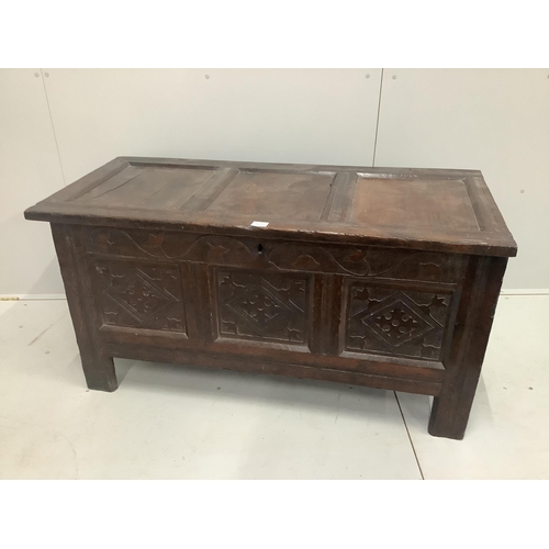 1205 - A 17th century and later panelled oak coffer with shallow carved foliate details, width 126cm