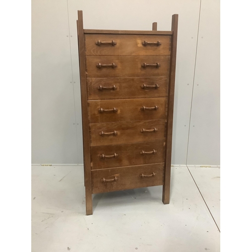 1238 - An Arts & Crafts oak seven drawer chest by Lawrence Tweedie of Derbyshire, width 67cm, height 142cm... 