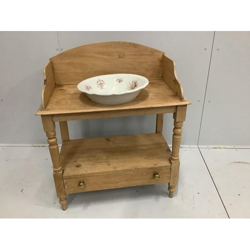 1239 - An Edwardian beech washstand with base drawer and associated ceramic basin, width 84cm