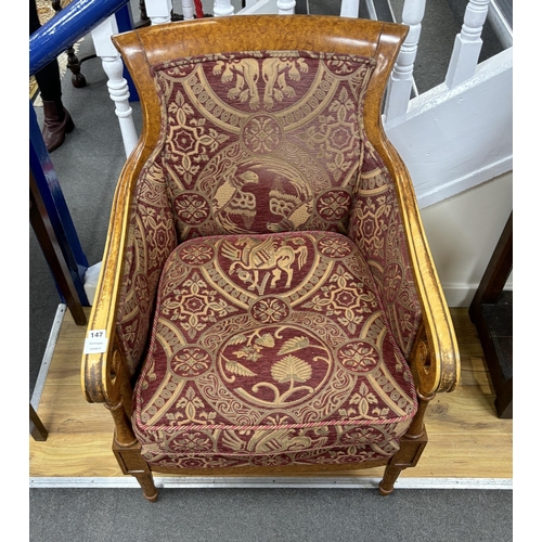 147 - An Empire style bergère armchair, width 67cm, depth 62cm, height 95cm