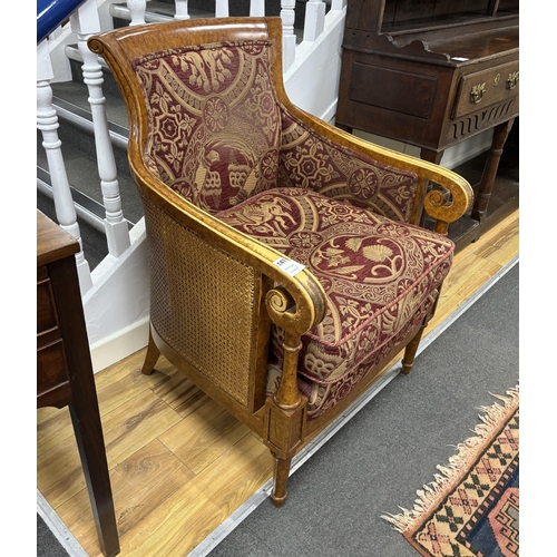 147 - An Empire style bergère armchair, width 67cm, depth 62cm, height 95cm