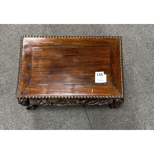 148 - A Chinese low rectangular hardwood stand carved with dragons, width 39cm, depth 25cm, height 21cm... 