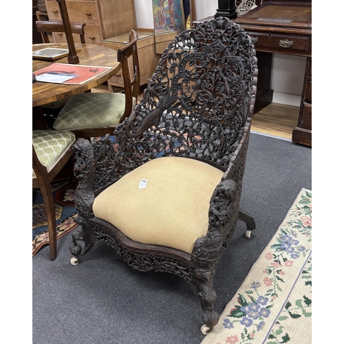 155 - An Anglo Indian carved hardwood armchair, width 75cm, depth 58cm, height 100cm