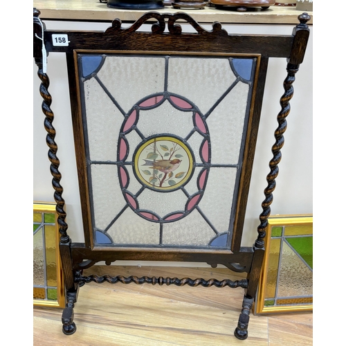 158 - An early 20th century stained glass oak firescreen, height 84cm together with a pair of Art Deco sty... 