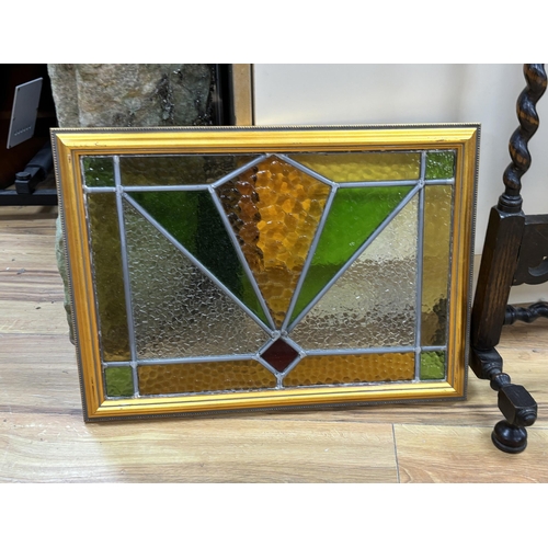 158 - An early 20th century stained glass oak firescreen, height 84cm together with a pair of Art Deco sty... 