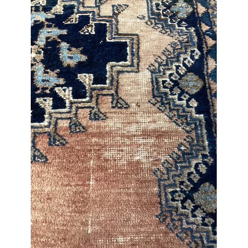 180 - A Caucasian red ground rug, 194 x 136cm