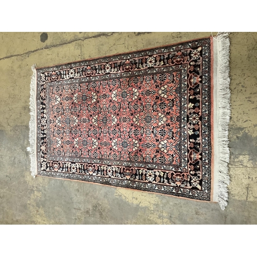 20 - A North West Persian peach ground rug,120 x 76cm