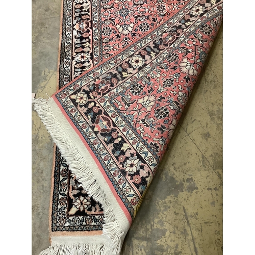 20 - A North West Persian peach ground rug,120 x 76cm