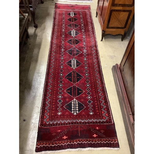 25 - A Turkish burgundy ground runner, 286 x 75cm