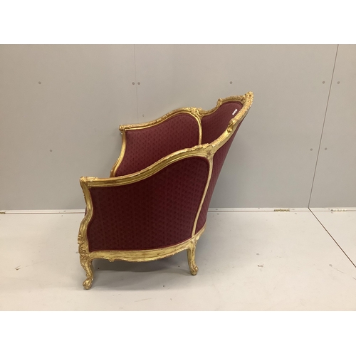 38 - A Louis XVI style carved giltwood tub framed salon chair, width 90cm, depth 70cm, height 90cm