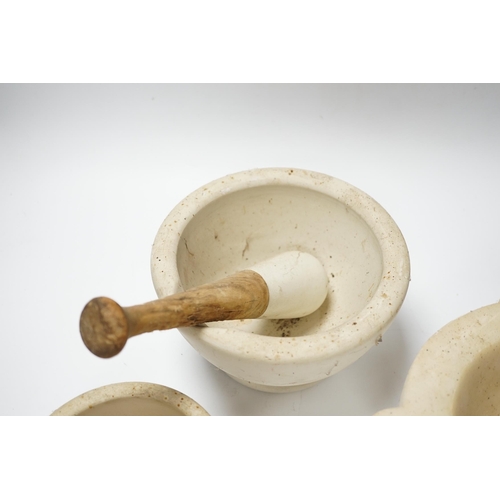 436 - Four mortars and three pestles, largest 23cm wide