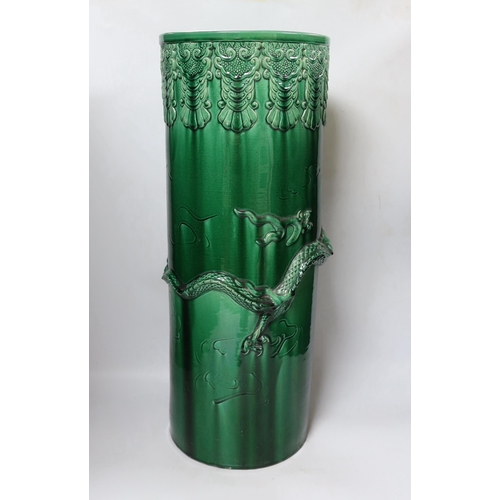 466 - An early 20th century Japanese green glazed dragon stick stand, 61cm