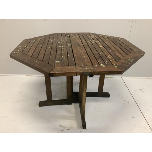 49 - A weathered octagonal teak garden table, width 120cm, height 73cm and four chairs