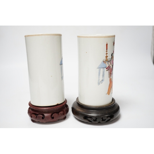 491 - A pair of Chinese cylindrical famille rose brush pots on associated stands, largest 15cm high overal... 