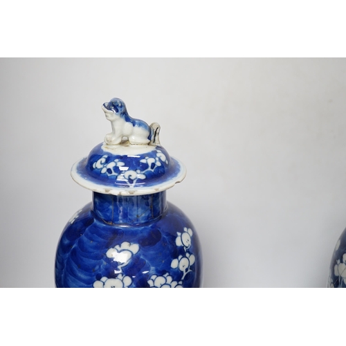 504 - Five early 20th century Chinese blue and white prunus vases and covers, tallest 31cm