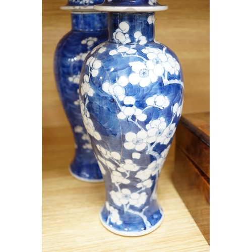 504 - Five early 20th century Chinese blue and white prunus vases and covers, tallest 31cm