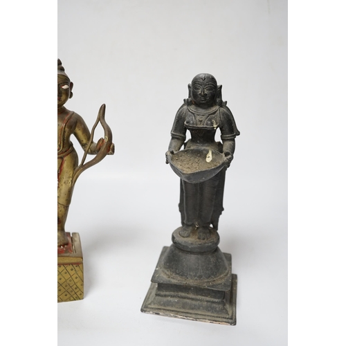 506 - A 19th century Indian Deepalakshni butter oil lamp and an 18th century Indian brass figure of Koda... 