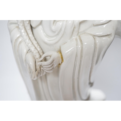 536 - A Chinese blanc de chine figure of Guanyin, 71cm with shade