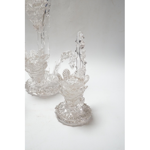 551 - A set of four glass stylistic floral candlesticks, (one double holder the other three single holder)... 