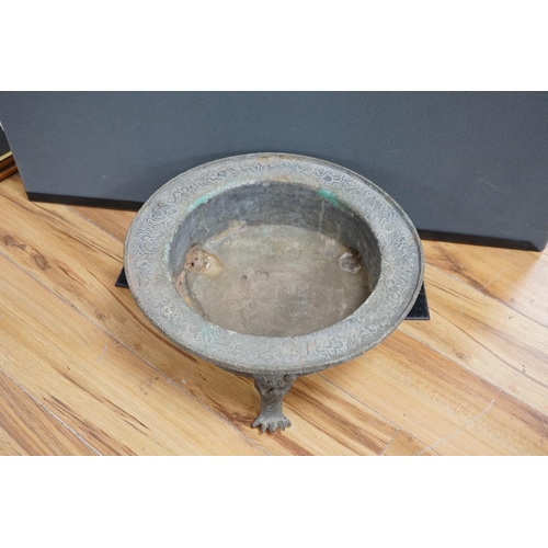 644 - A large and heavy Chinese bronze tripod basin, Xuande mark but 19th century, the broad rim cast in r... 