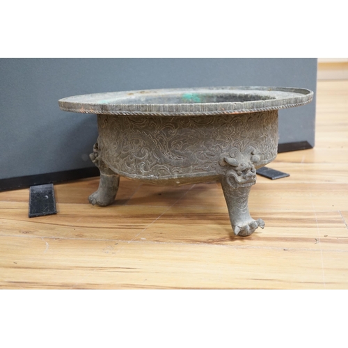 644 - A large and heavy Chinese bronze tripod basin, Xuande mark but 19th century, the broad rim cast in r... 