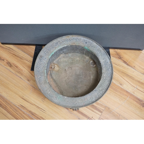 644 - A large and heavy Chinese bronze tripod basin, Xuande mark but 19th century, the broad rim cast in r... 