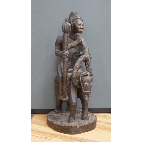 647 - A West African tribal figure of a warrior on horseback, probably Dogon, 57cm high