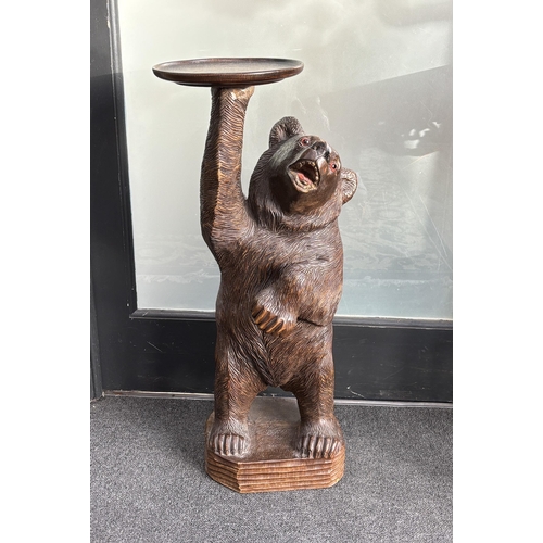 651 - A large Black Forest figure of a bear, with later oak dish top, 71cm high