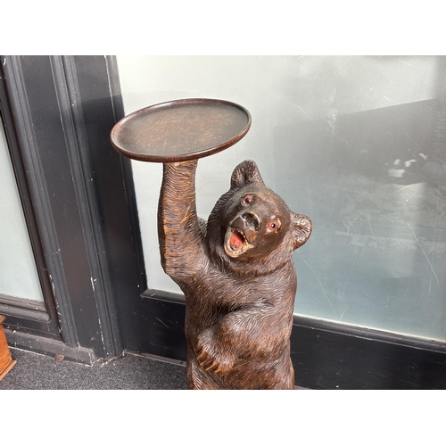 651 - A large Black Forest figure of a bear, with later oak dish top, 71cm high